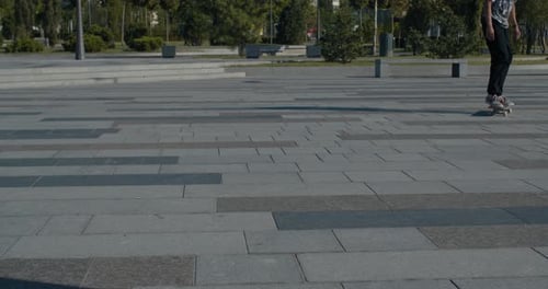 Young Adult Performs Skateboard Trick in Urban Area