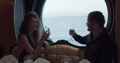 Young Beautiful Couple Having Romantic Dinner on Cruise Ship.