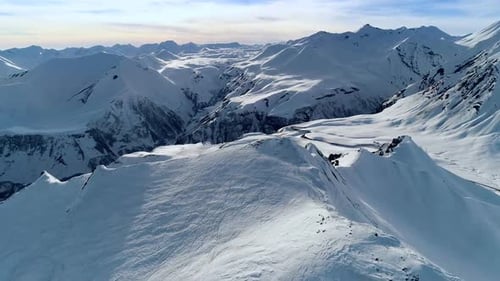Aerial View of Snowy Mountain Range in Winter