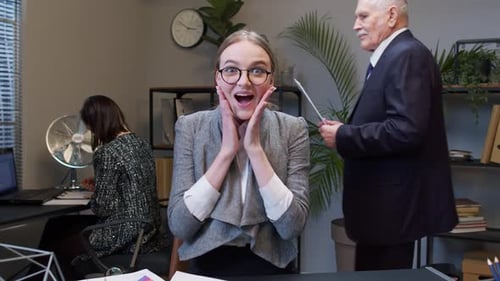 Young Woman Excited About Documents in Office