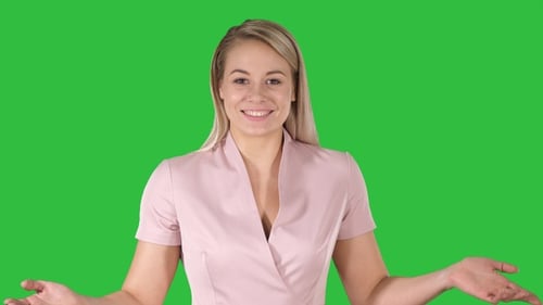 Woman in pink talking to the camera on a Green Screen, Chroma Key