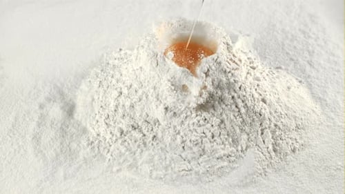 The Super Slow Motion of the Fresh Egg Falls Into the Pile of Flour