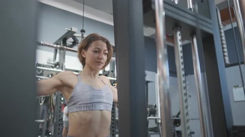 Fitness Girl Is Exercising with in a Gym. Sporty Woman Is Lifting a Weight. Fitness, Body and Health