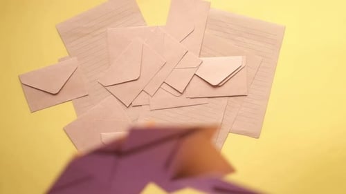 Brown Envelopes and Lined Paper on Yellow Background