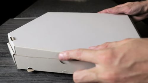 Opening a Delicious Pizza Takeout Box