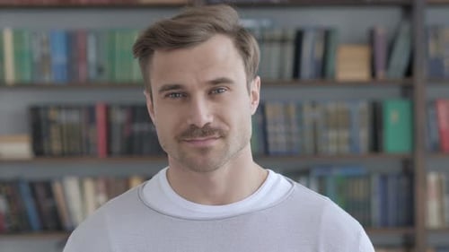 Smiling Man Gives Thumbs Up and Winks