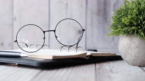 Office Still Life with Notebook, Glasses, and Pen