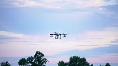 Drone Flies in Sky at Golden Hour