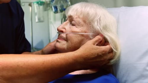 Nurse examining a senior patient in the ward 4k