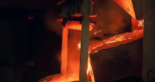 Molten Metal Pouring in Dark Industrial Factory