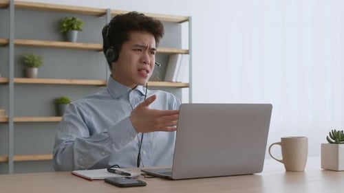 Young Adult in Video Conference at Desk