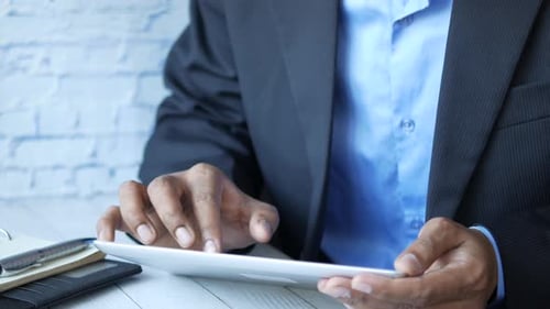 Businessman Using Digital Tablet on Office Desk