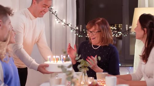 Woman Celebrates Birthday with Family and Cake