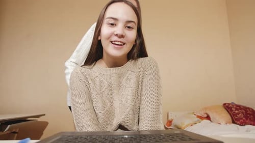 Smiling Young Woman Video Chatting at Home