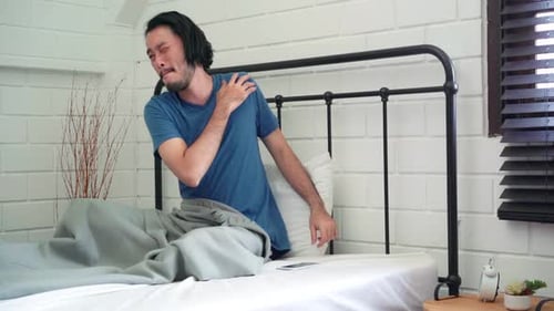 Sleepy Man Stretches and Wakes Up in Bed