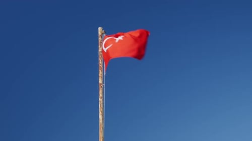 Flag Waving Against Clear Blue Sky