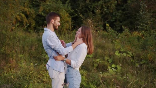 Closeup of a Beautiful Girl and Boy Hugging in a Park