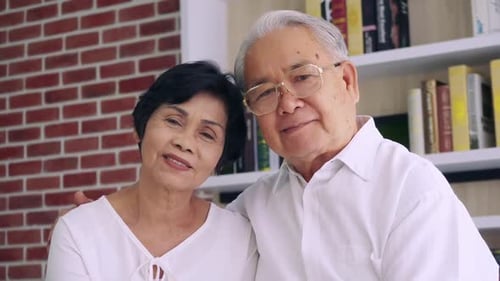 Happy Senior Couple Holding Hands and Smiling