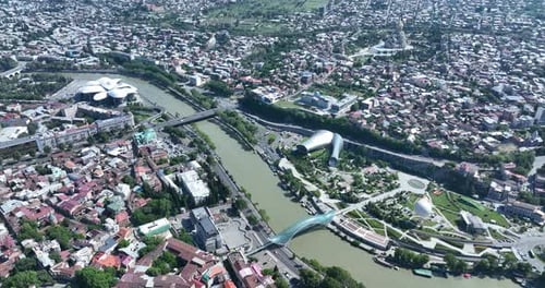 Aerial view of Tbilisi city central park and Bridge of Peace. Beautiful cityscape of old Tbilisi at