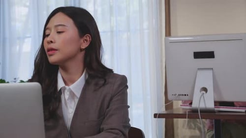 Woman Working on Laptop in Office