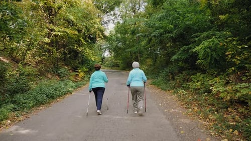 Senior Women Walking in the Autumn Forest