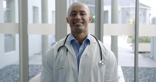 Smiling Man Wearing Doctor's Coat and Stethoscope