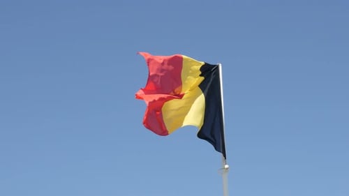 Belgian Flag Waving Against Blue Sky