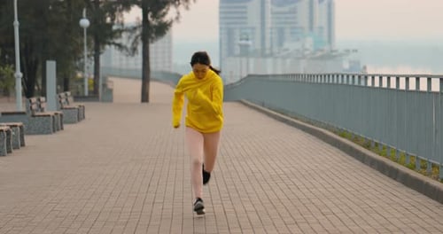 Young Woman Running In The Park