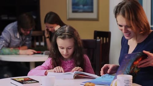 Girl Reads with Adult Assistance