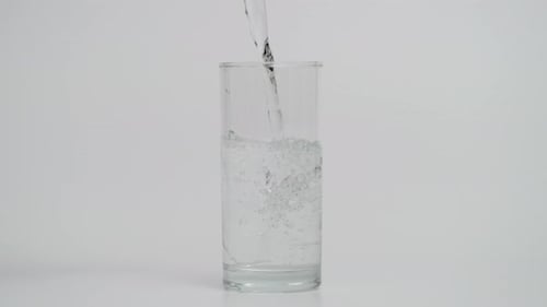 Liquid Being Poured Into a Tall Glass