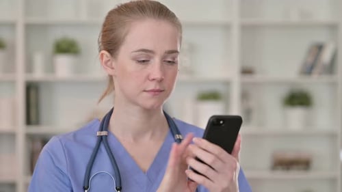 Woman Doctor Using Smartphone Indoors