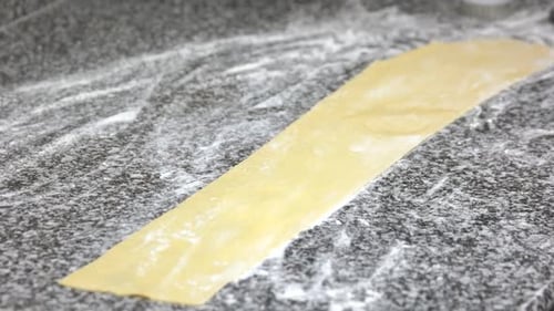 Hand Brushing Liquid on Dough Sheet