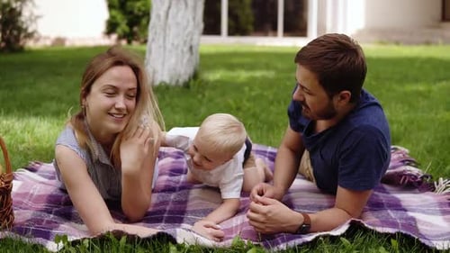 Loving Family Enjoying Sunny Picnic on Grass