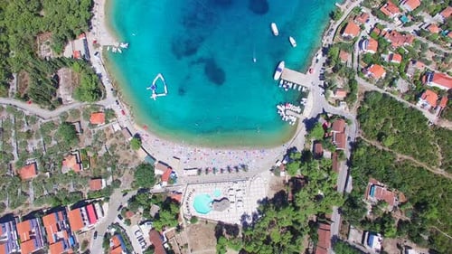 Flying above touristic resort at turquoise bay of Solta island
