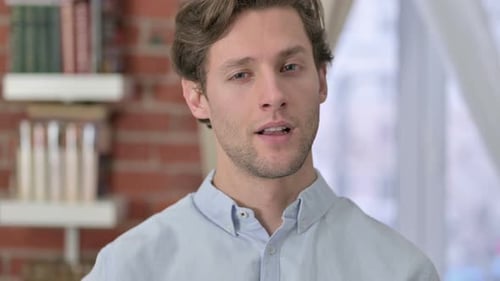 Young Man Gives Approval with an 'Ok' Sign