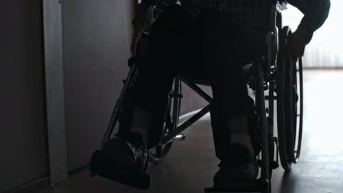 Silhouette of Male Patient Riding Wheelchair