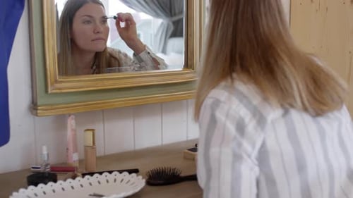 Beautiful Woman Putting on Mascara in Morning