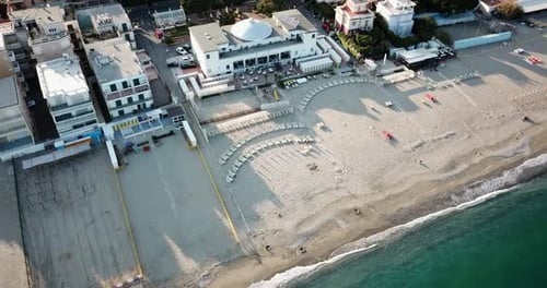 Top view of a italian sandy Mediterranean beach, during a sunset. Genoa, Italy