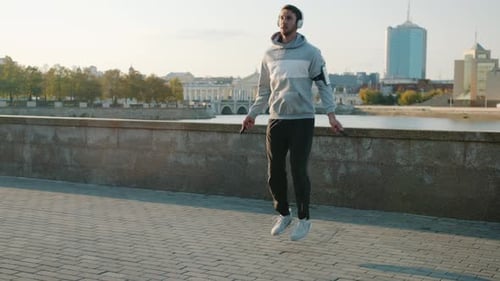 Man Jumps Rope on City Sidewalk