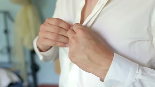 Man Buttons Crisp White Dress Shirt, Close-Up