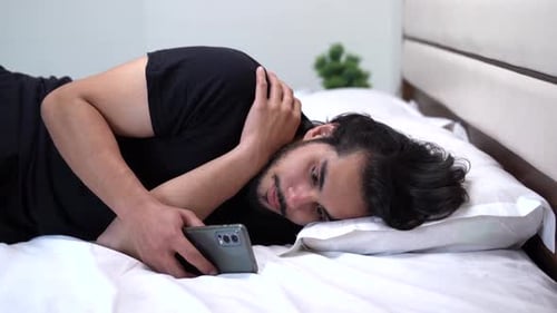 Indian man scrolling the phone at night