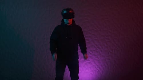 Young Adult Using Virtual Reality Headset and Controllers