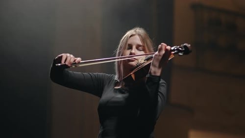 Young Woman Plays Violin with Passion and Skill