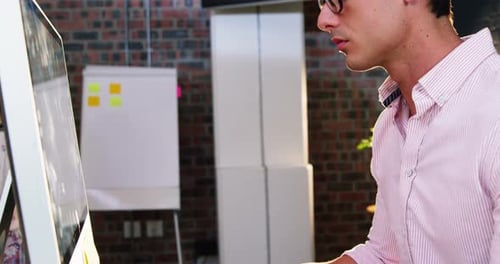 Young Adult Designer Working at Desk