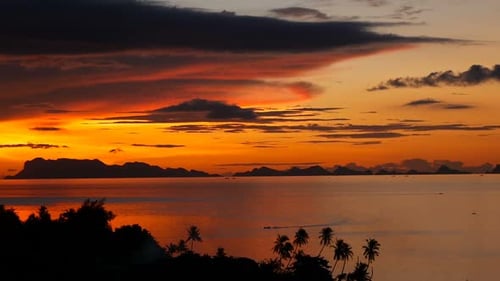 Majestic Tropical Orange Summer Real Time Sunset Over Sea with Mountains Silhouettes. Aerial View of