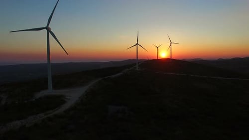 Aerial view of windmills at beautiful colorful sunset