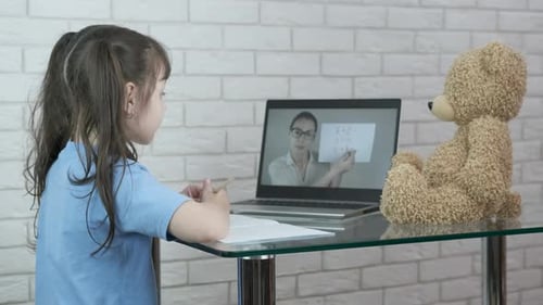 Girl Learning Online with Laptop and Teacher