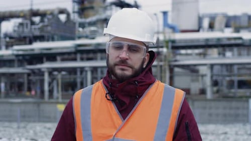 Portrait of Engineer in Hard Hat Goggles Safety Uniform Industrial Background