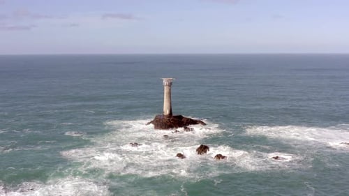 Isolated Lighthouse at Sea on a Rock During the Summer