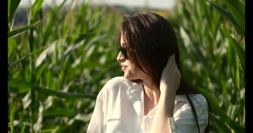 Pretty Young Woman Enjoying Sun in Corn Field